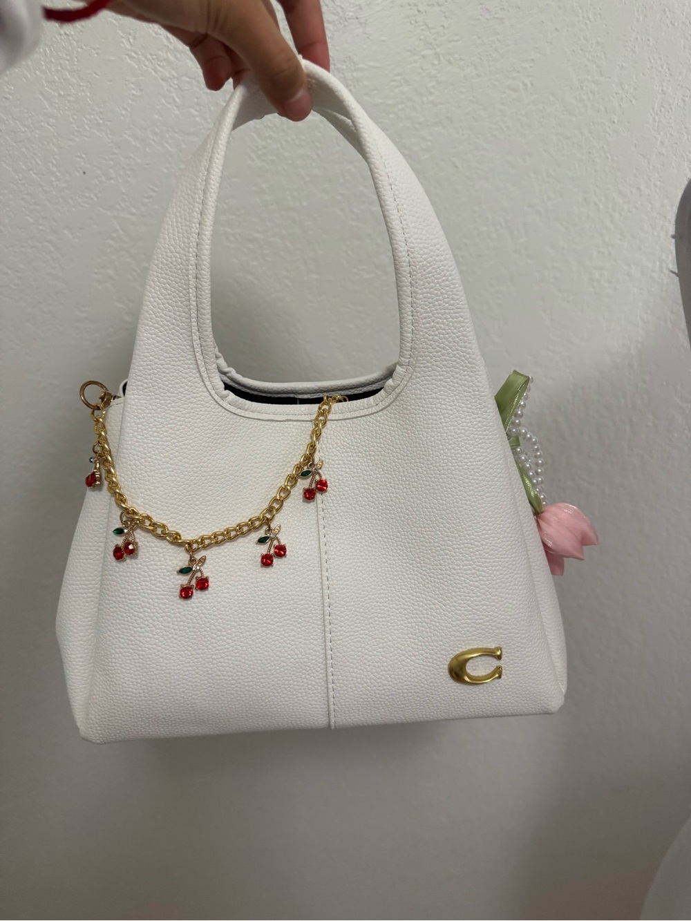Coach White Pebbled Top-Handle Shoulder Bag with Gold Chain and Red Charms